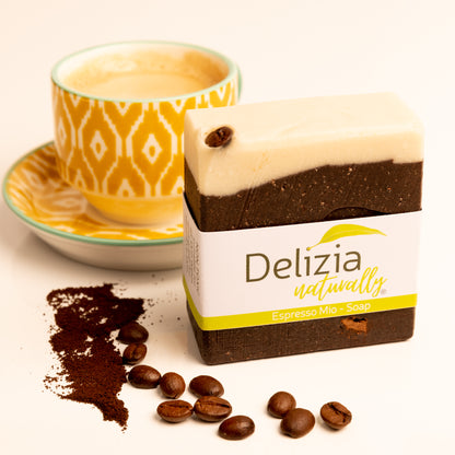 Delizia naturally Espresso Mio  tallow soap bar with coffee beans and a cup of coffee in the background