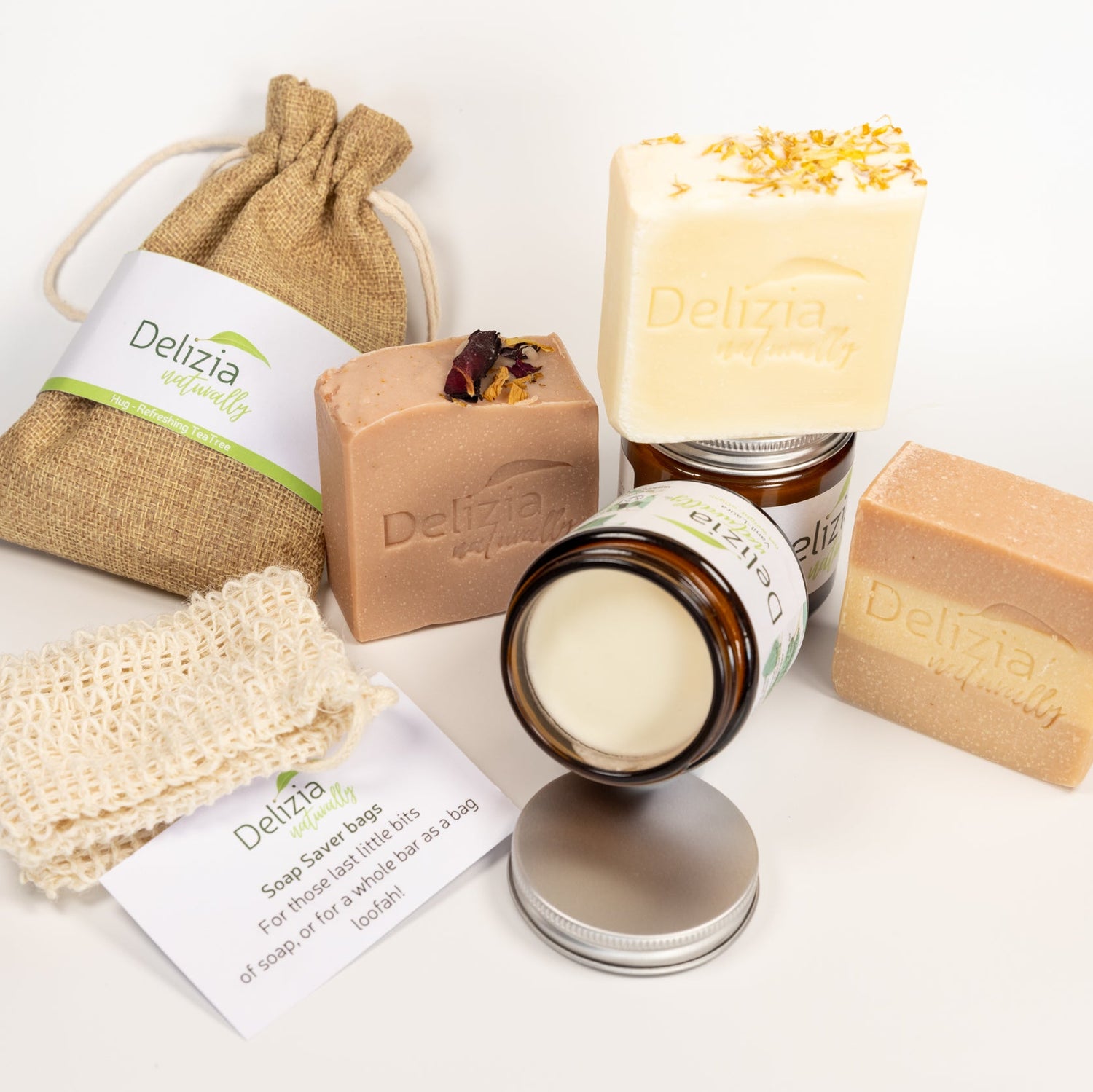 Delizia skincare products including soap, cream, and bags on a white background